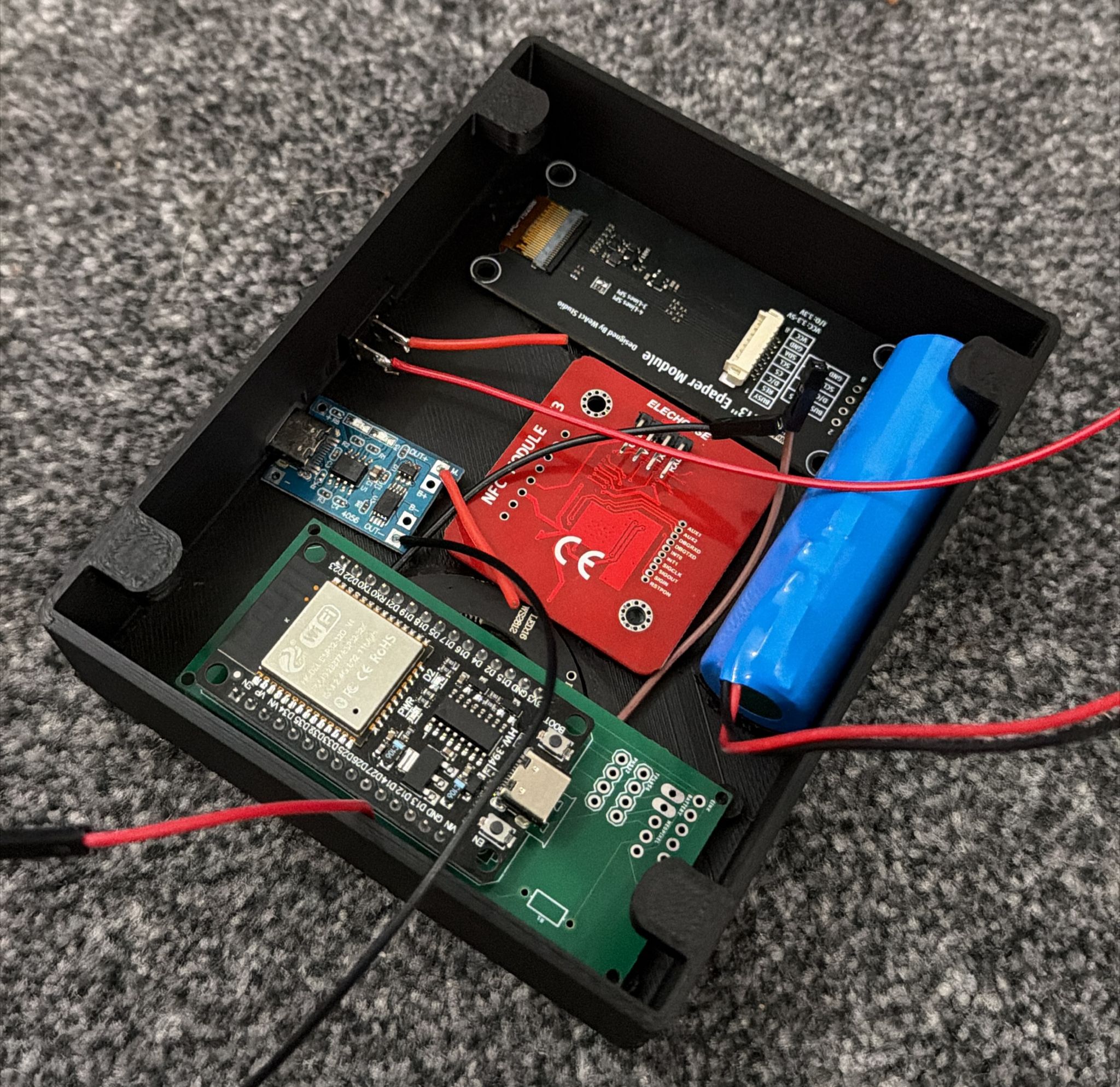 Jellybox internals: ESP32, PN532 NFC reader, Waveshare eInk, TP4056 charging board, and 18650 cell laid into the printed shell